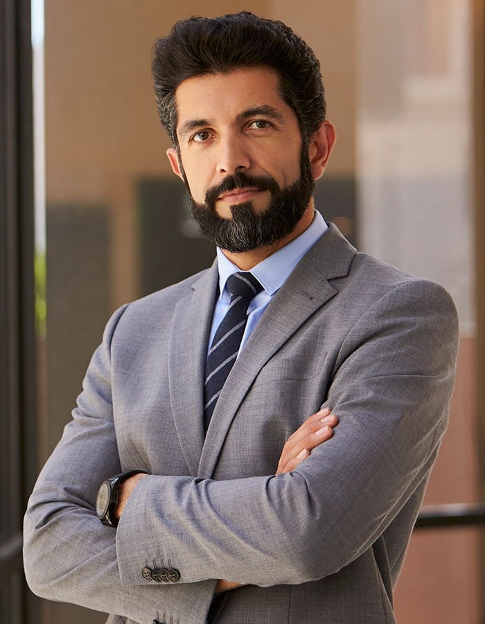 hispanic-businessman-with-arms-crossed-looking